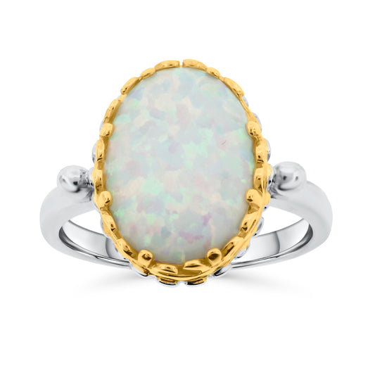 Sterling silver ring featuring oval lab-created white opal in decorative gold bezel with beaded band details
