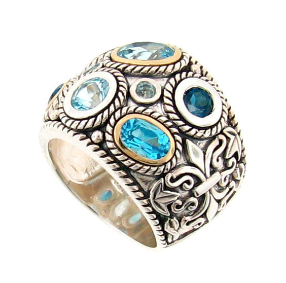 Sterling silver dome ring with multiple blue topaz stones in various cuts, featuring 14K gold bezels and intricate rope-twist detailing