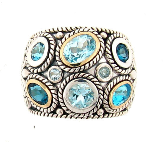 Sterling silver dome ring with multiple blue topaz stones in various cuts, featuring 14K gold bezels and intricate rope-twist detailing