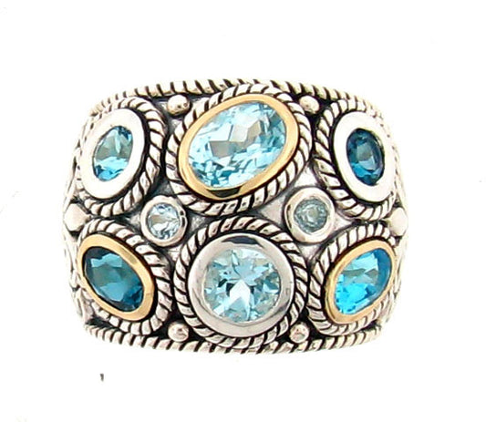 Sterling silver dome ring with multiple blue topaz stones in various cuts, featuring 14K gold bezels and intricate rope-twist detailing